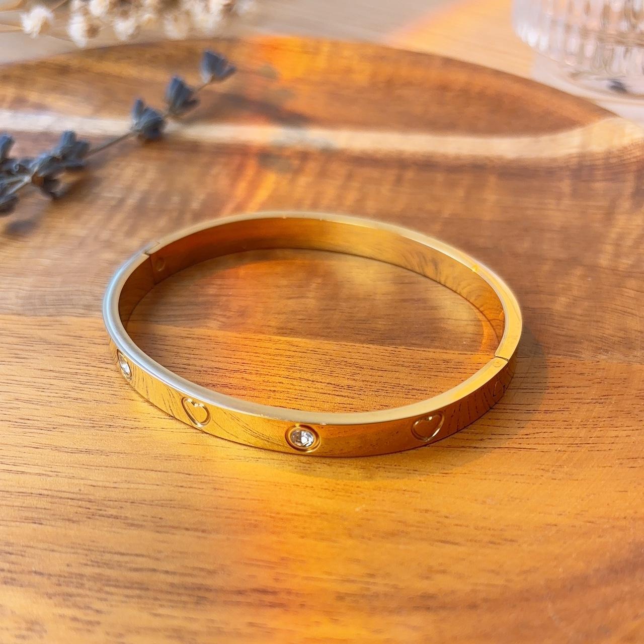 Heart engraved embellished gold bangle