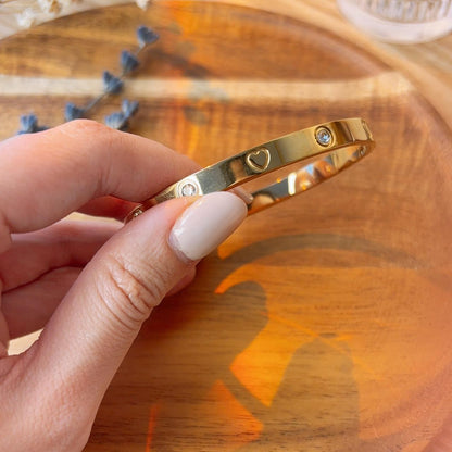 Heart engraved embellished gold bangle