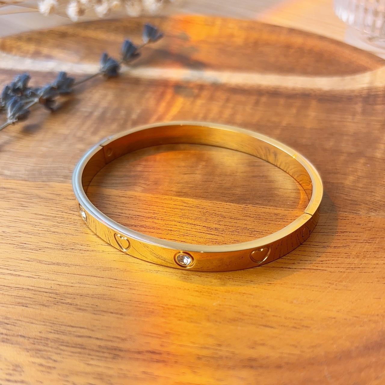 Heart engraved embellished gold bangle