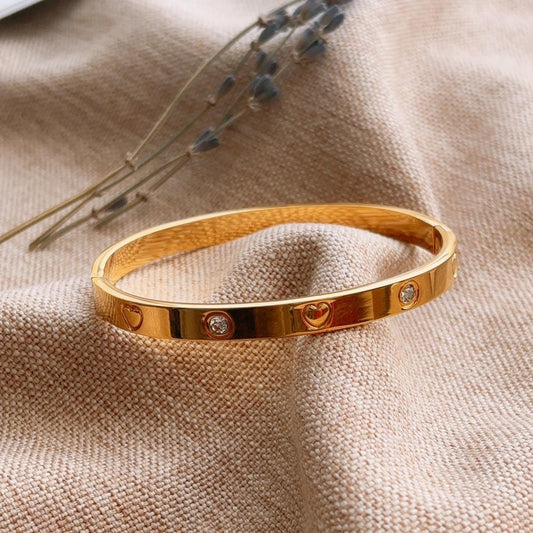 Heart engraved embellished gold bangle