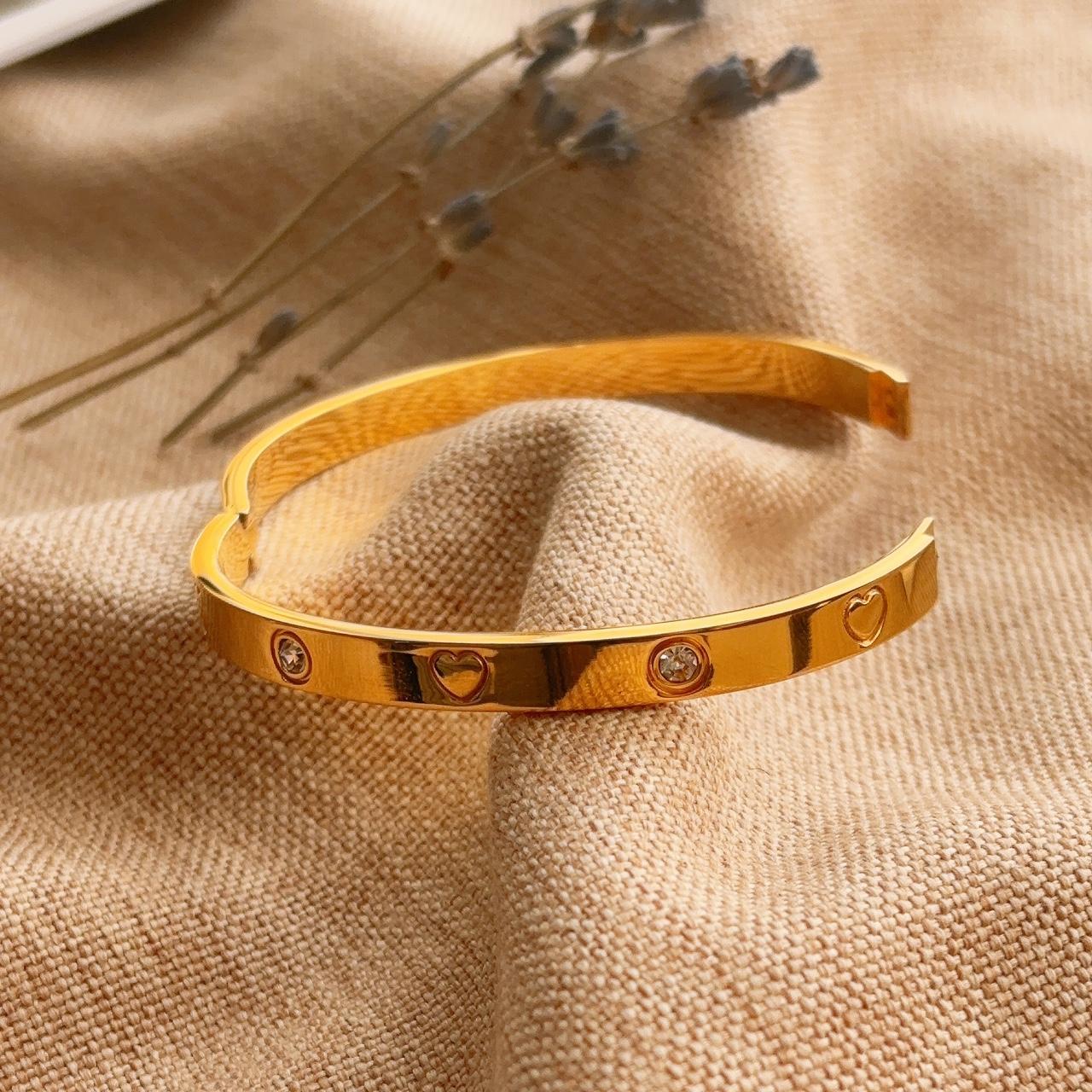 Heart engraved embellished gold bangle