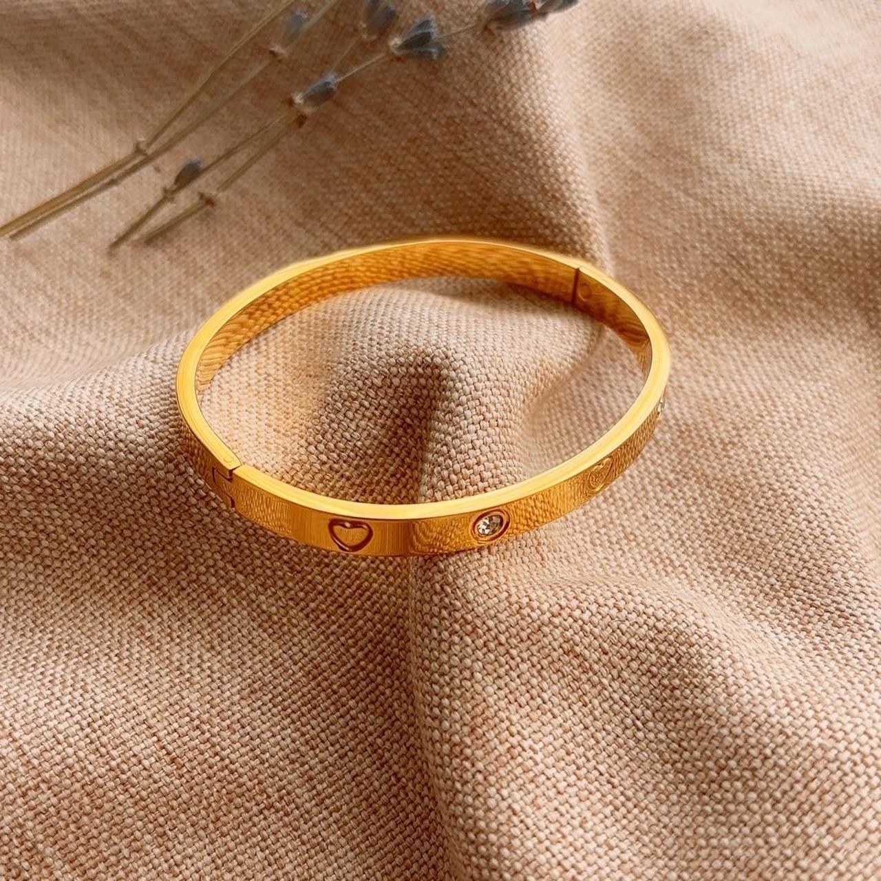 Heart engraved embellished gold bangle